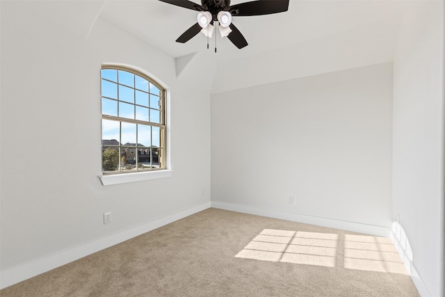 carpeted empty room with ceiling fan and lofted ceiling