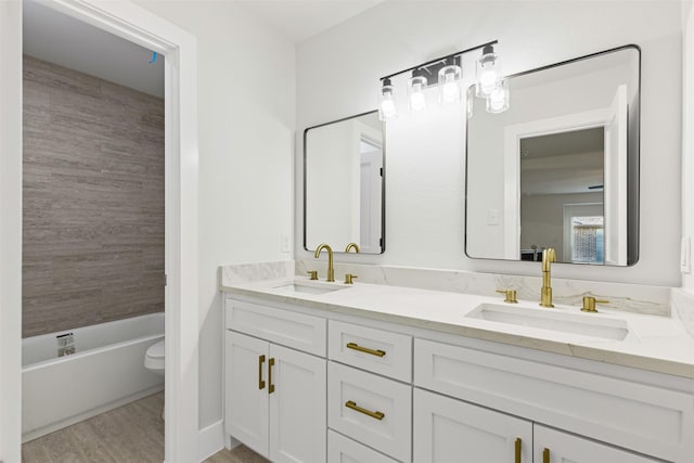 full bathroom with toilet, vanity, tub / shower combination, and hardwood / wood-style flooring