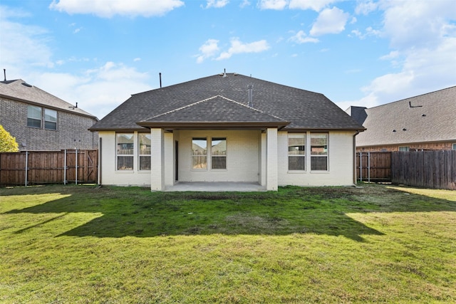 back of house featuring a yard and a patio