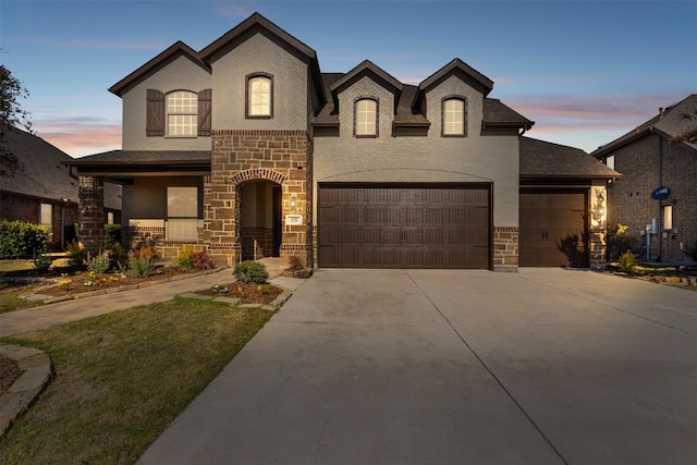 french country inspired facade featuring a garage