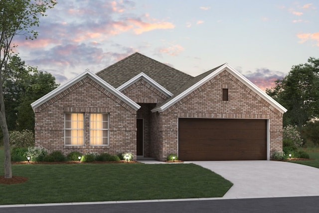 view of front of home featuring a garage and a yard