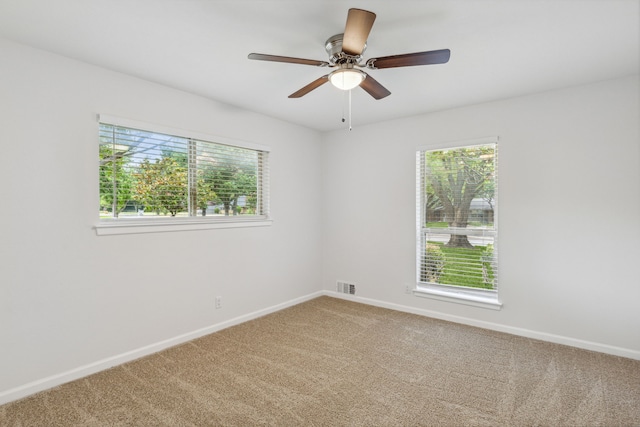 unfurnished room featuring ceiling fan and carpet floors