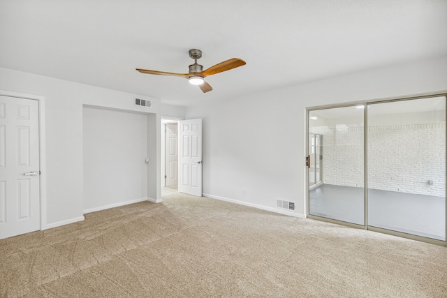 unfurnished bedroom with ceiling fan, ensuite bathroom, and carpet flooring