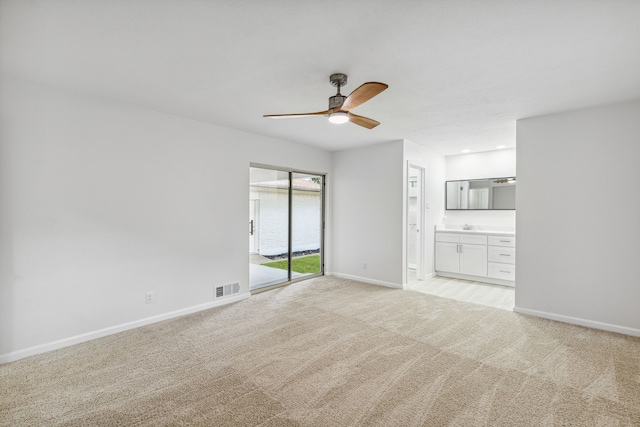 carpeted empty room featuring ceiling fan