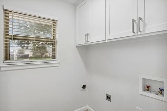 clothes washing area with cabinets, hookup for a washing machine, and hookup for an electric dryer