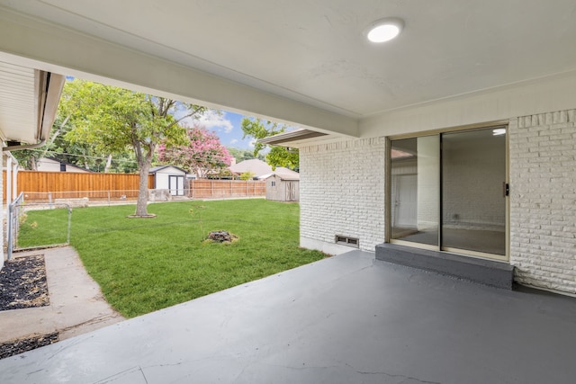 view of yard featuring a patio and a storage unit