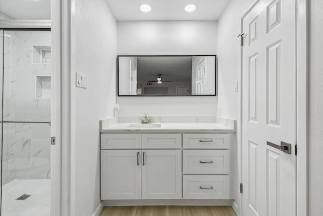 bathroom with an enclosed shower, vanity, and hardwood / wood-style flooring