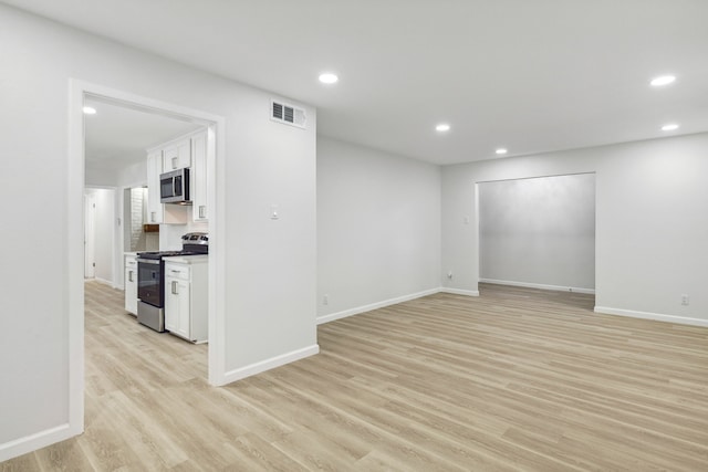 unfurnished living room with light hardwood / wood-style flooring