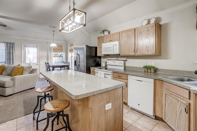 kitchen with white appliances, vaulted ceiling, decorative light fixtures, a kitchen island, and a breakfast bar area