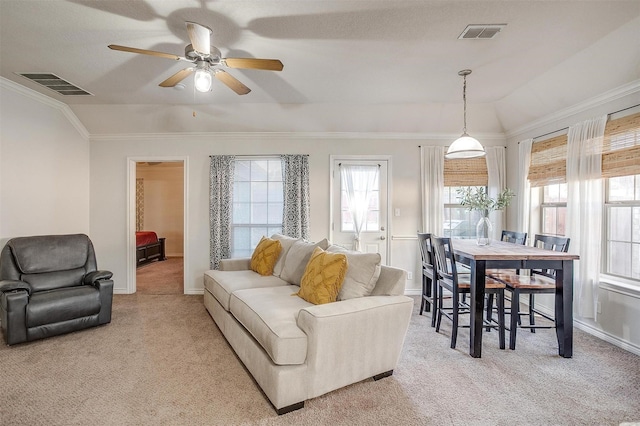 carpeted living room with ceiling fan, lofted ceiling, and ornamental molding