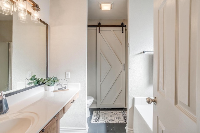 bathroom featuring toilet, vanity, a tub to relax in, and tile patterned floors