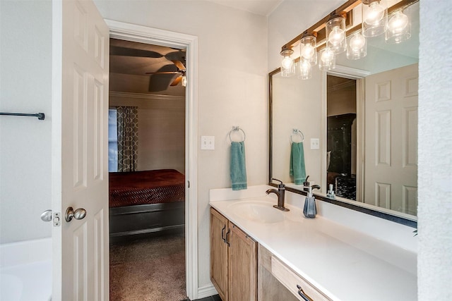 bathroom with ceiling fan, a bathtub, and vanity