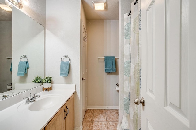 bathroom with tile patterned floors and vanity