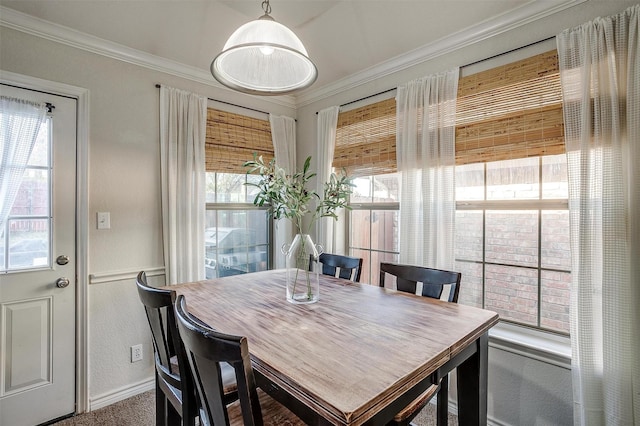 dining room with carpet floors, crown molding, and a healthy amount of sunlight