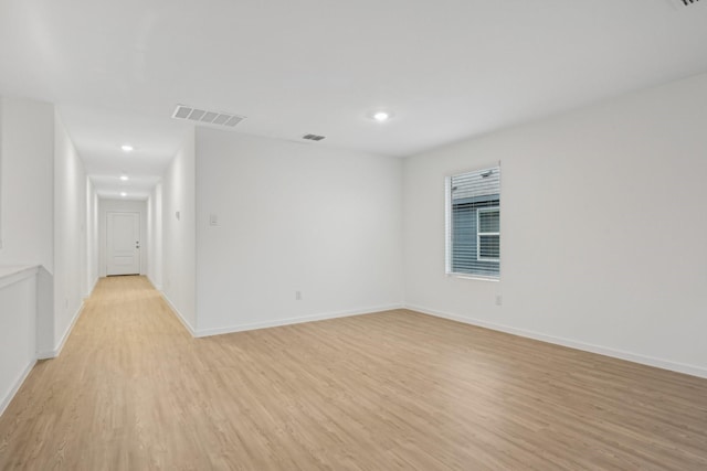 unfurnished room with light wood-type flooring