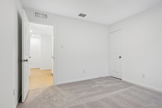 unfurnished room featuring light carpet