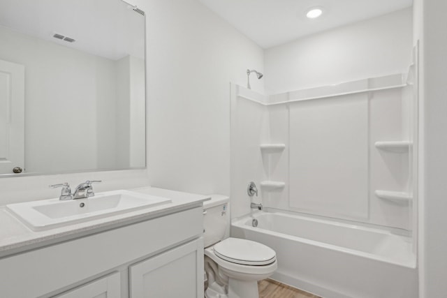 full bathroom with vanity, tub / shower combination, wood-type flooring, and toilet