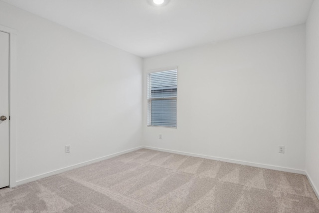 empty room featuring light colored carpet