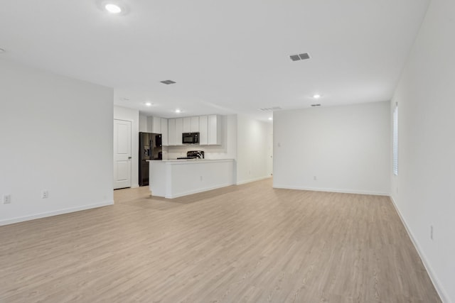 unfurnished living room featuring light hardwood / wood-style flooring