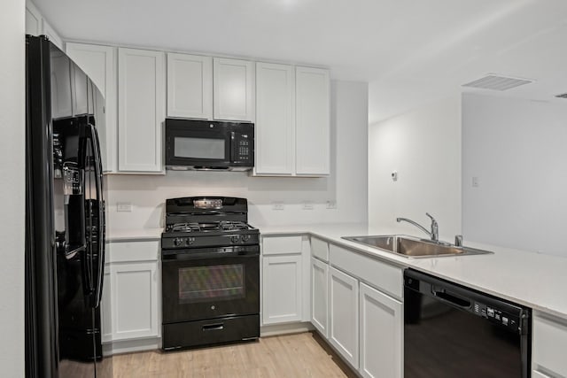 kitchen featuring white cabinetry and black appliances