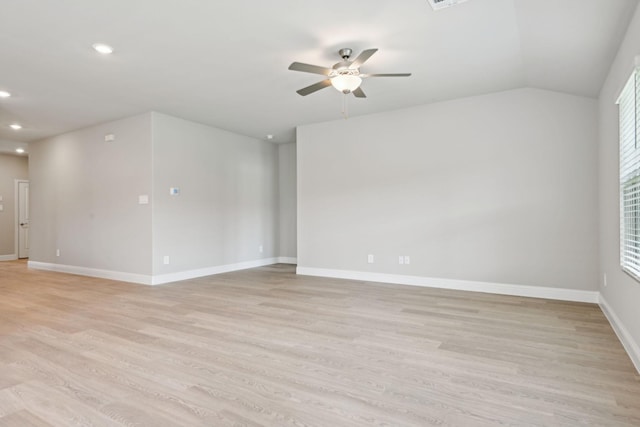 empty room with light wood-type flooring, vaulted ceiling, and ceiling fan