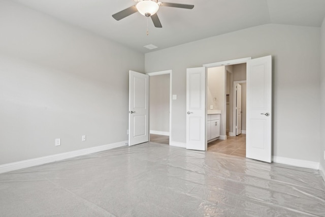 unfurnished bedroom featuring ceiling fan, connected bathroom, and vaulted ceiling