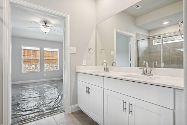 bathroom with ceiling fan, a shower with door, and vanity