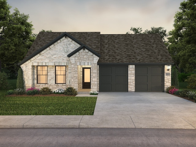 view of front of property featuring a lawn and a garage