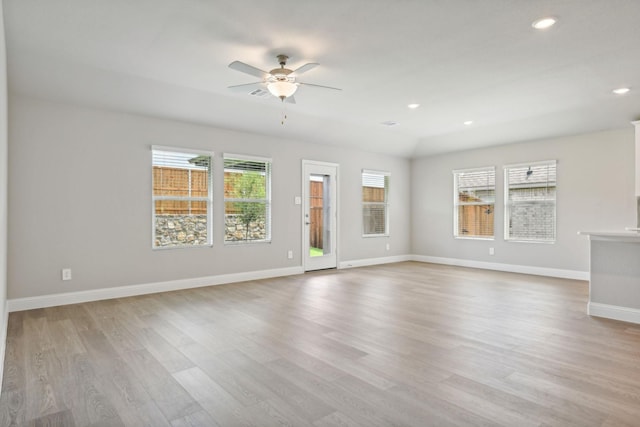 unfurnished living room featuring ceiling fan and light hardwood / wood-style floors