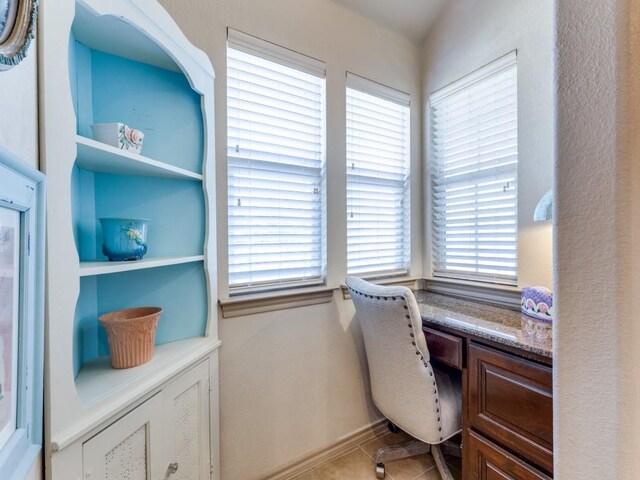 tiled office featuring built in desk and plenty of natural light