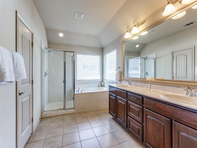 bathroom with tile patterned flooring, lofted ceiling, and shower with separate bathtub