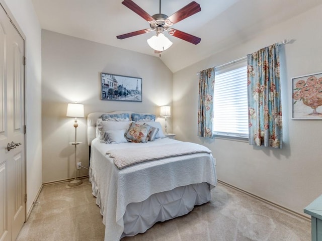 bedroom with ceiling fan, light colored carpet, and lofted ceiling