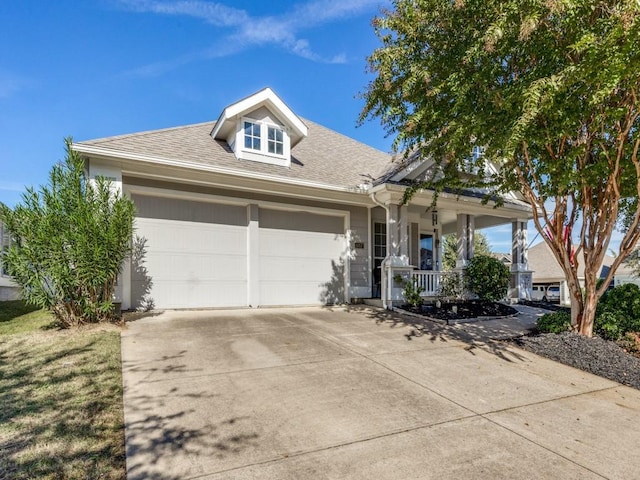 view of front of property with a porch and a garage