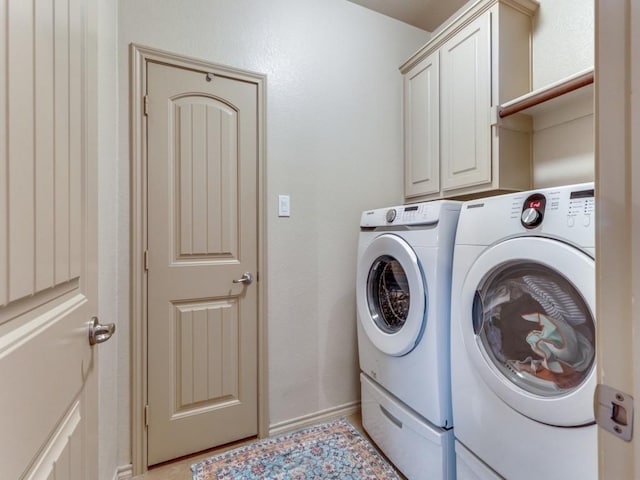 laundry room featuring cabinets and separate washer and dryer