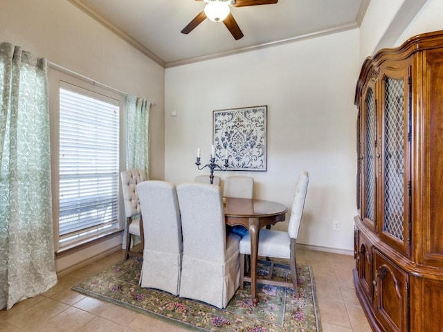 tiled dining room with crown molding and ceiling fan