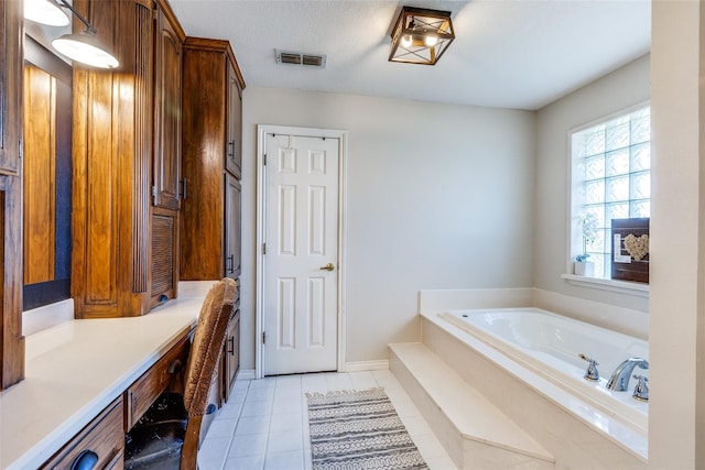 bathroom featuring tile patterned flooring and a washtub