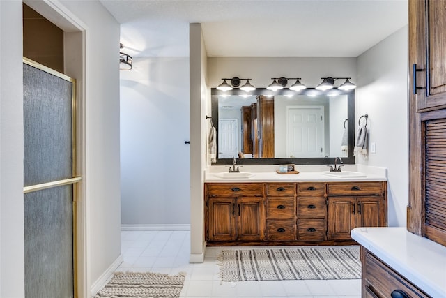 bathroom featuring tile patterned floors, vanity, and an enclosed shower