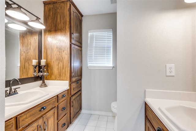 bathroom featuring tile patterned flooring, vanity, and toilet