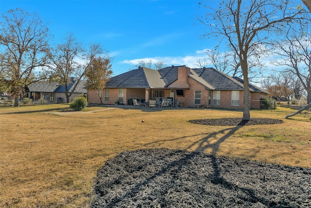 exterior space with a front lawn and a patio