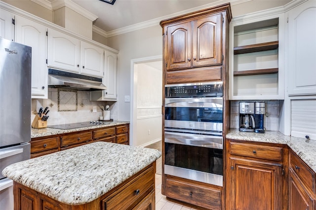 kitchen with light stone countertops, tasteful backsplash, crown molding, a kitchen island, and appliances with stainless steel finishes