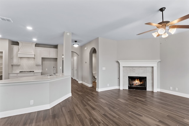 kitchen featuring sink, white cabinets, dark wood-type flooring, and custom exhaust hood