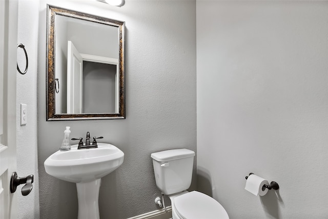 bathroom with toilet and sink