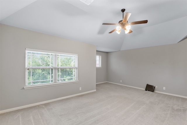 carpeted empty room with ceiling fan and lofted ceiling