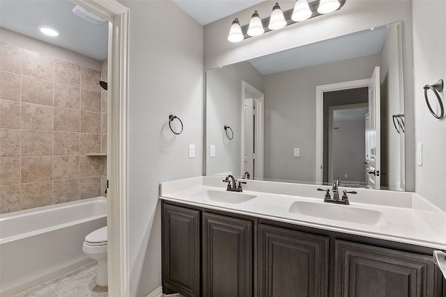 full bathroom featuring vanity, toilet, and tiled shower / bath