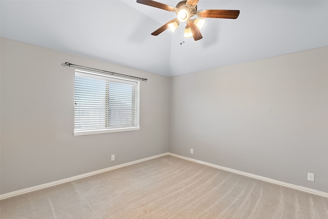 carpeted empty room with vaulted ceiling and ceiling fan