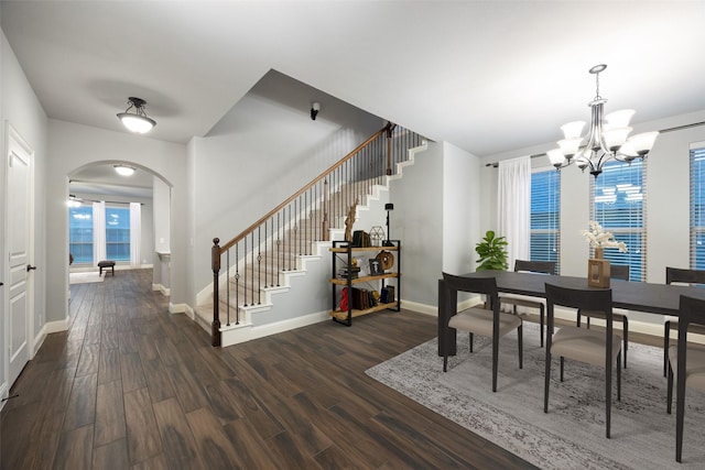 dining space featuring dark wood-type flooring and a chandelier