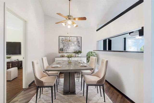 dining room with ceiling fan, wood-type flooring, and lofted ceiling