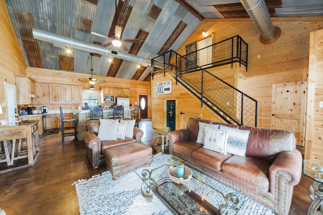 living room featuring beamed ceiling, high vaulted ceiling, ceiling fan, and wooden walls