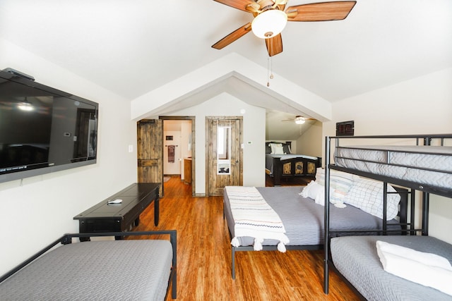 bedroom featuring light hardwood / wood-style flooring, ceiling fan, and lofted ceiling