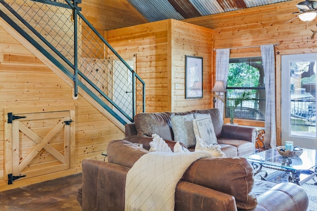 living room featuring lofted ceiling and wooden walls